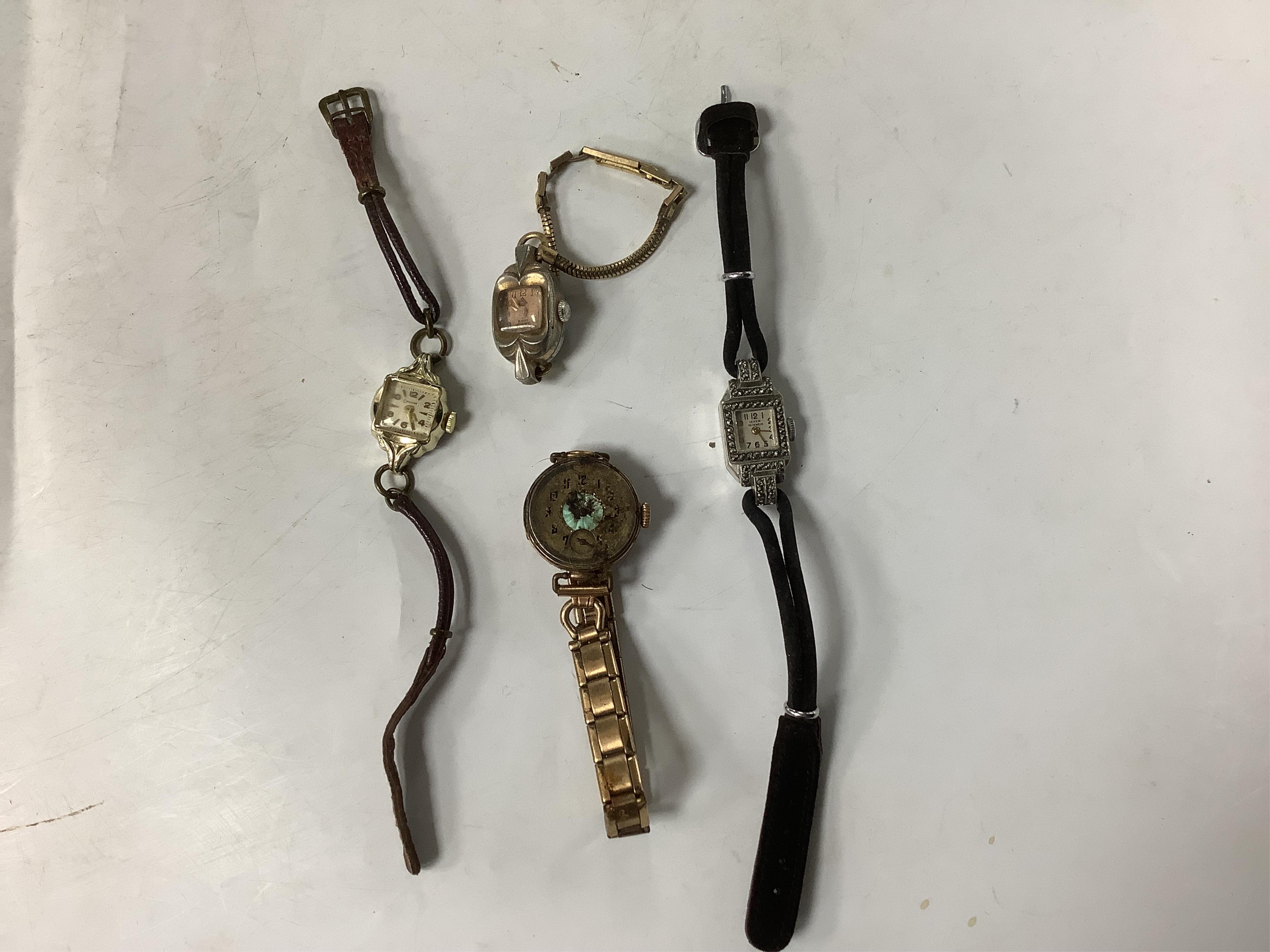 A 9ct cased manual wind wrist watch(a.f.), together with three another assorted lady's wrist watches including marcasite set steel cased.